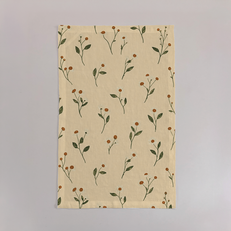 Aurelia Crisp Linen tea towels with butter-yellow ground and olive botanical stems; sold as a set of two; one towel shown flat.