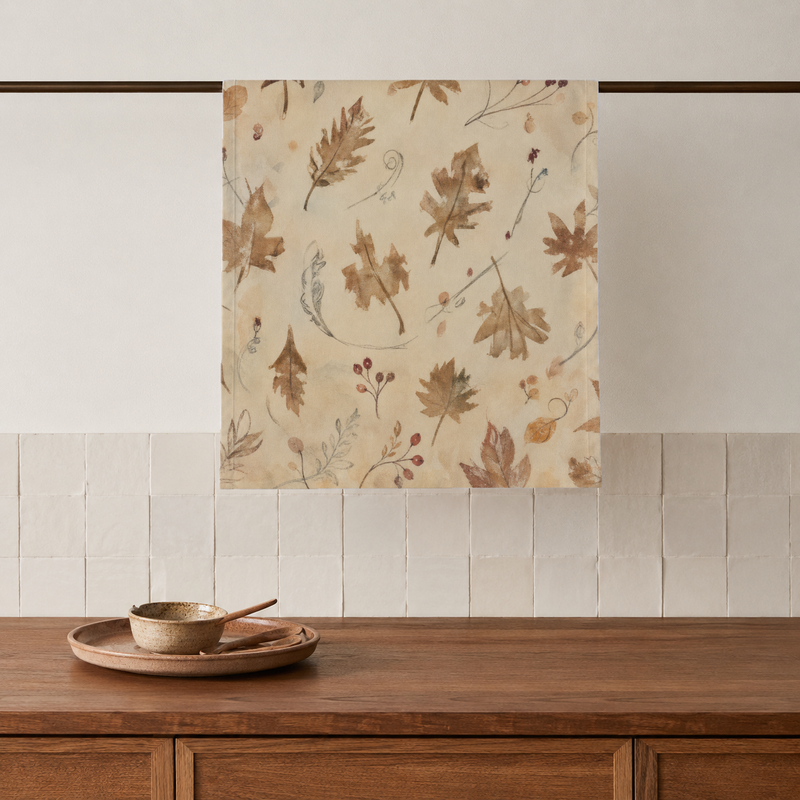 Coppice Fine Flatweave tea towels with chestnut oak leaves on parchment; sold as a set of two; one towel styled on a kitchen rail; props are not included.