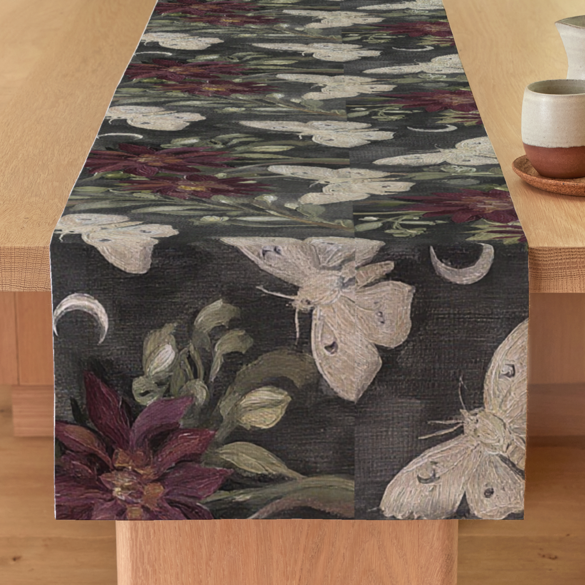 Lune Noire Moth Botanical Linen Table Runner — Charcoal & Burgundy; styled product view. One table runner.