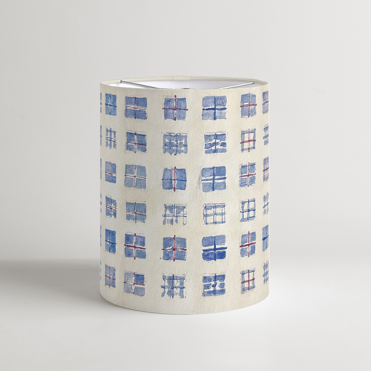 Vesper tall drum lampshade with hand-painted blue grid squares and burgundy accents on parchment.