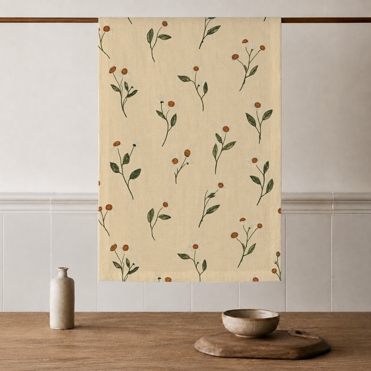 Aurelia Crisp Linen tea towels with butter-yellow ground and olive botanical stems; sold as a set of two; one towel styled on a kitchen rail; props are not included.