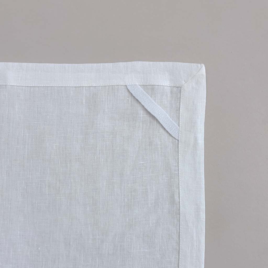 Aurelia Crisp Linen tea towels with butter-yellow ground and olive botanical stems; sold as a set of two; plain reverse, hem and hanging loop detail.