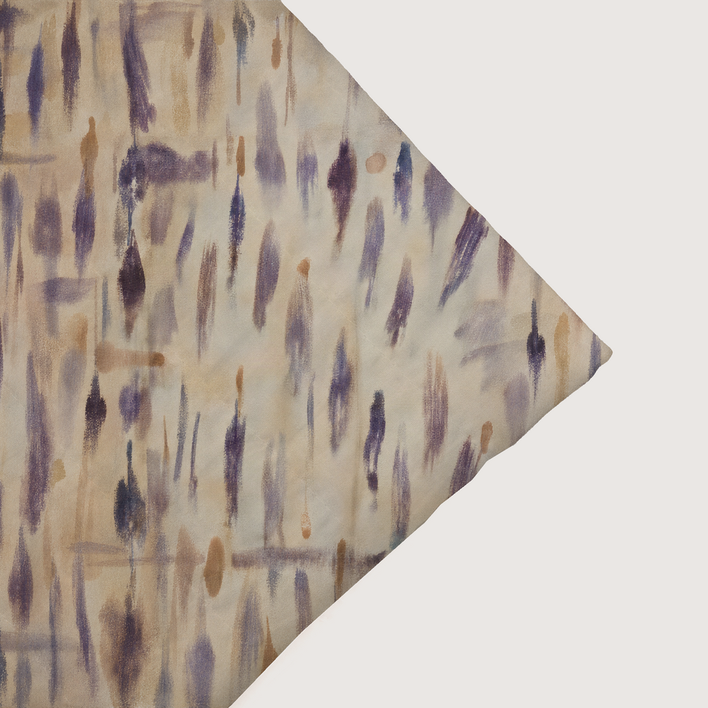 Cadenza coverlet close-up showing painterly print and a sewn edge.
